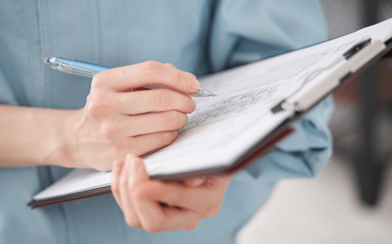 a woman holding a clipboard